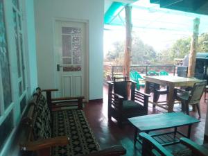 a room with tables and chairs and a table and a table and chairs at Forest Cyniciam Homestay in Ohiya