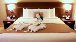 a hotel room with towels on a bed at Tryp by Wyndham Panama Centro in Panama City