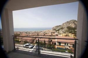 a balcony with a view of the ocean and buildings at Case Vacanze Adelaide in Cefalù