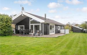 a small house with a deck and a lawn at 3 Bedroom Nice Home In Sams in Nordby