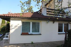 a white house with a red roof at Pension Hanspaulka in Prague