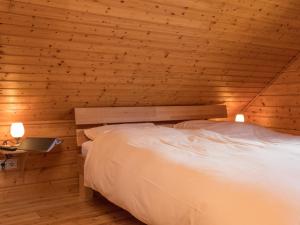 a bedroom with a bed in a wooden cabin at Semi-detached house, Hasselfelde in Hasselfelde