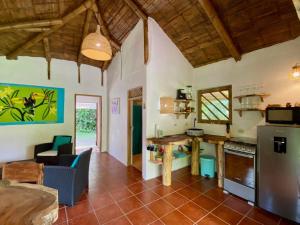 a kitchen and living room with a table and a stove at Casa Lavanda in tropical jungle garden in Manzanillo