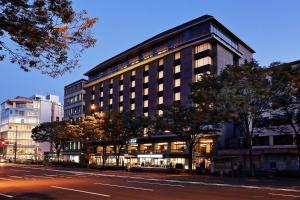 a large building on a city street at night at Hotel Honnoji in Kyoto