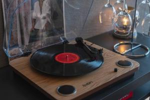a vinyl record sitting on a wooden cutting board at プライベートリゾート日暖 in Taga
