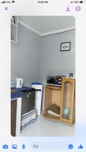 a small kitchen with a stove and a microwave at LP Madriaga Private Apt fully furnished w/Balcony in Ayusan Norte