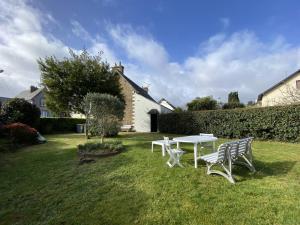 stół piknikowy i dwie ławki na dziedzińcu w obiekcie Maison bretonne avec jardin, 2 chambres, centre de Perros-Guirec, proche plages et commerces - FR-1-368-385 w mieście Perros-Guirec