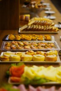 a row of trays filled with different types of pastries at Verdant hotel in Bonito