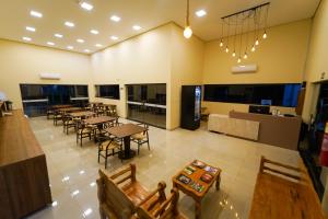 a large room with tables and chairs in it at Verdant hotel in Bonito