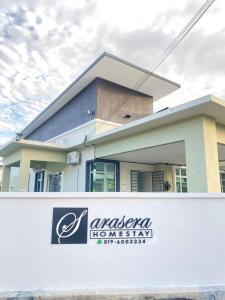 a building with a sign in front of it at SARASERA HOMESTAY with PRIVATE POOL MELAKA in Malacca