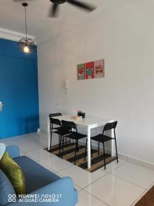 a dining room with a white table and chairs at Platino Aparment @ Paradigm Mall in Johor Bahru