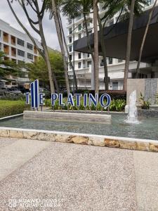 a sign in front of a building with a fountain at Platino Aparment @ Paradigm Mall in Johor Bahru