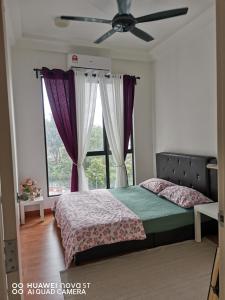 a bedroom with a bed and a window with purple curtains at Platino Aparment @ Paradigm Mall in Johor Bahru