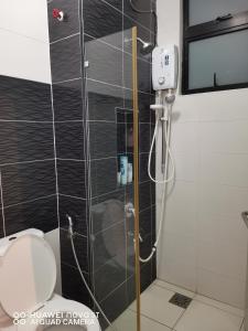 a shower in a bathroom with a toilet at Platino Aparment @ Paradigm Mall in Johor Bahru