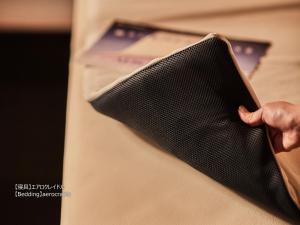 a person holding a black napkin in a pocket at First Cabin Nishi Umeda in Osaka