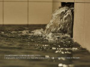 a close up of water coming out of a fountain at First Cabin Nishi Umeda in Osaka