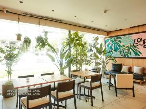 a restaurant with tables and chairs and a large window at First Cabin Nishi Umeda in Osaka