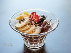 a plastic cup filled with ice cream and desserts at First Cabin Nishi Umeda in Osaka