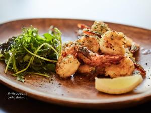 a plate of food with shrimp and a salad at First Cabin Nishi Umeda in Osaka