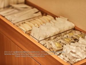 a drawer full of towels and toilet paper at First Cabin Nishi Umeda in Osaka