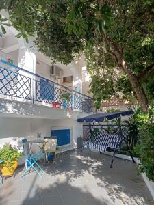 a patio with a table and chairs and a balcony at Villa Stegiovana in Stavros