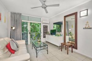 a living room with a couch and a table at Tropic Apartment 103 Palm Cove in Palm Cove
