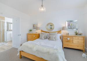 a bedroom with a large bed with a wooden headboard at Argraig in Abersoch