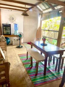 a room with a wooden table and a bench at Casita Francisco Siargao in General Luna
