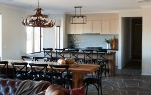 a kitchen and dining room with a table and chairs at Buttercup Retreat in Merrijig