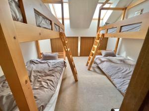 a room with two bunk beds in a room at TESHIKAGA HOSTEL MISATO in Teshikaga