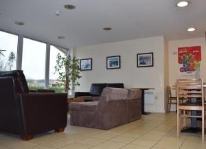 a living room with a couch and a table at Eyesleepover in Eyemouth