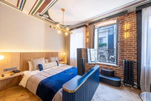 a bedroom with a bed and a brick wall at Hotel Balo in Istanbul