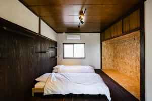 una camera da letto con due letti e una finestra di 島のまくら a Kure