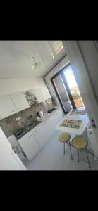 a kitchen with two chairs and a table and a sink at Studio Mamaia-Nord in Mamaia Nord