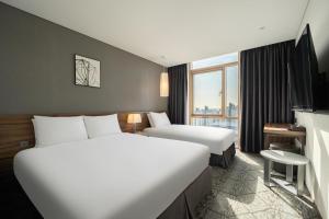 Staz Hotel Ulsan客房内的一张或多张床位