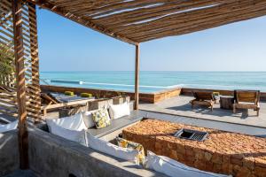 an outdoor patio with a view of the ocean at Bamboo Zanzibar in Jambiani
