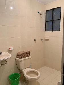 a bathroom with a toilet and a sink and a shower at Casa Mila in Taxco de Alarcón