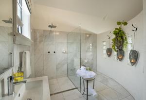 a white bathroom with a shower and a sink at The Villa in Morpeth