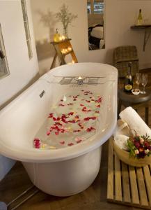 
a white bath tub sitting on top of a wooden floor at The Villa in Morpeth
