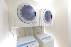 two machines and a washing machine in a room at HOTEL MYSTAYS Kamata in Tokyo