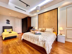 a bedroom with a large bed and a desk at Anggun Residences Luxury Suites KL City Center in Kuala Lumpur