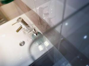 a bathroom sink with a faucet and a glass cup at V CENTRU dění in Olomouc