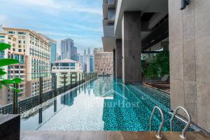 a swimming pool on the roof of a building with a city skyline at Anggun Residences Luxury Suites KL City Center in Kuala Lumpur