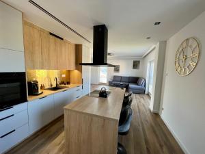 a kitchen with a large island in a room at Złoty Apartament in Tykocin