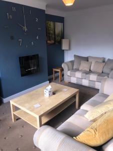a living room with two couches and a coffee table at 2 Bedroom Bungalow in Mawdesley
