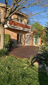 a house with a large deck in front of it at Le Domaine de Charline de 1 à 35 personnes in Issel