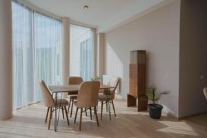 a dining room with a table and chairs at Tilia Kvareli Resort in Kvareli