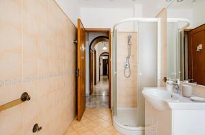 La salle de bains est pourvue d'un lavabo et d'une douche. dans l'établissement Mi casa tu casa - Guest House, à Catane