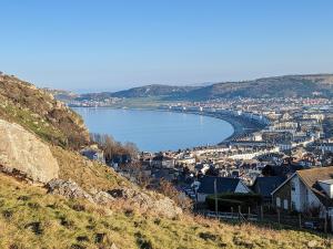 a view of a town and a body of water at White Cottage in Llandudno
