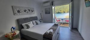 a small bedroom with a bed and a large window at Apartment Sea Dream in Ston